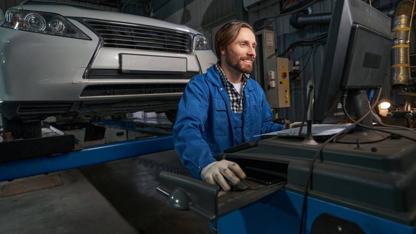 Portrait of mechanic working at computer in service center