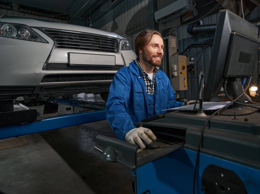 Portrait of mechanic working at computer in service center